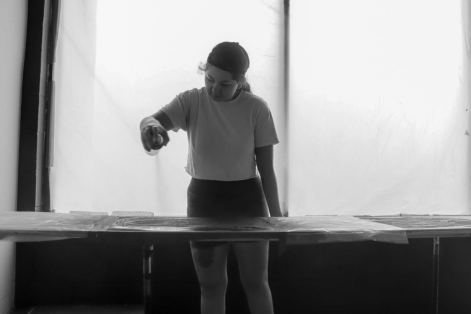 Spraypainting the logo on a table.